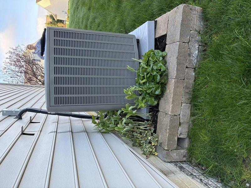 Responded to callback regarding AC unit stability concerns following installation. Upon arrival, inspected outdoor condenser unit and found equipment properly positioned on concrete pad consisting of multiple pavers arranged in rectangular configuration. Unit exhibited no signs of instability or improper installation. Verified all refrigerant lines, electrical connections, and conduit properly secured to exterior wall. Confirmed concrete pad installation meets manufacturer specifications and industry standards. Equipment operating within normal parameters with no structural or mechanical issues identified. Documented installation with photographs showing stable mounting, proper clearances, and professional workmanship. Customer concerns addressed through visual inspection and explanation of proper installation methods.