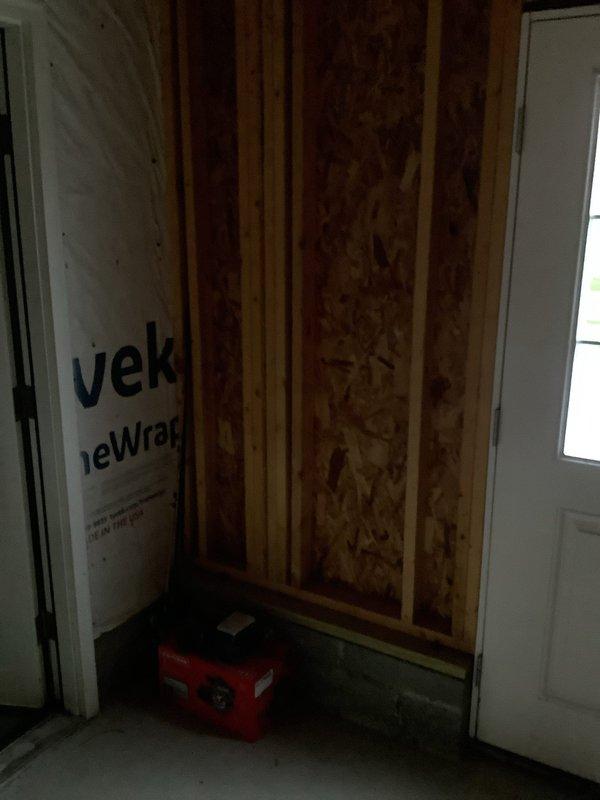Conducted on-site assessment for electrical panel replacement in residential property undergoing renovation. Evaluated existing breaker box configuration, which contained dual rows of circuit breakers with multiple branch circuits serving the dwelling. Documented current panel condition, wire routing, and main service connections to provide accurate replacement quote. Noted installation location features exposed wall framing with OSB sheathing and protective plastic sheeting in work area, indicating active construction environment requiring coordination with ongoing renovation work.