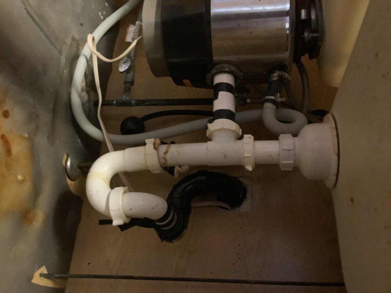 Responded to service call for water leaks under kitchen sink and at exterior spigots. Inspected under-sink plumbing assembly including PVC P-trap configuration, compression fittings, and garbage disposal unit connections. Identified leak sources at drain connections and addressed failing seals. Tightened compression fittings and replaced deteriorated gaskets as needed. Checked exterior hose bibs for leaks and performed necessary repairs to stop water loss. Documented existing water filtration system during inspection. All leak points were successfully repaired and tested for proper operation.
