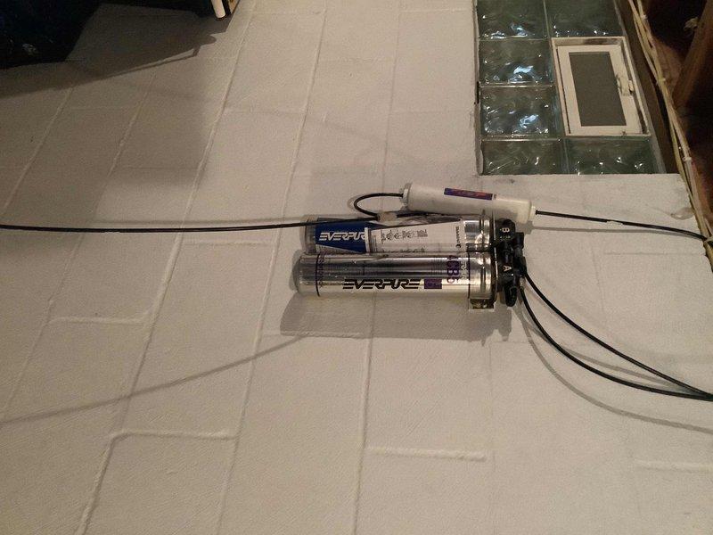 Responded to service call for water leaks under kitchen sink and at exterior spigots. Inspected under-sink plumbing assembly including PVC P-trap configuration, compression fittings, and garbage disposal unit connections. Identified leak sources at drain connections and addressed failing seals. Tightened compression fittings and replaced deteriorated gaskets as needed. Checked exterior hose bibs for leaks and performed necessary repairs to stop water loss. Documented existing water filtration system during inspection. All leak points were successfully repaired and tested for proper operation.