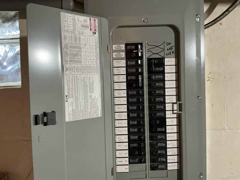 Conducted on-site electrical assessment for standby generator installation. Evaluated existing electrical infrastructure including main service panel capacity, available circuit breaker positions, and current electrical load distribution. Documented gas meter location and utility connections in basement area to determine optimal generator placement and fuel supply routing. Photographed electrical panel configuration showing circuit layout and available capacity for generator transfer switch integration. Assessment completed to provide comprehensive estimate for generator system installation including required electrical upgrades and transfer switch specifications.