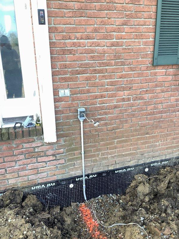 Responded to emergency electrical repair call for damaged wiring at commercial property undergoing foundation excavation work. Upon arrival, assessed electrical conduit and wiring that had been compromised multiple times during foundation waterproofing and drainage installation activities. The electrical line running along the exterior brick wall and into the excavation trench had become frayed and broken due to repeated contact with construction equipment and materials during the dig-out process. Repaired damaged electrical conduit and replaced compromised wiring to restore safe electrical service to the business facility.