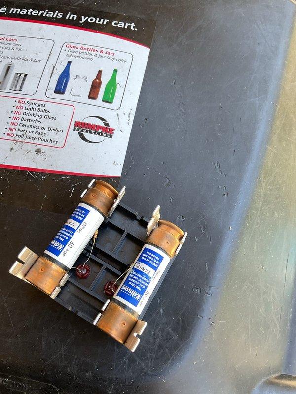 Replaced faulty fuse holder inside outdoor AC disconnect switch. New fuse block installed with proper fuses to restore safe electrical operation to the condensing unit.