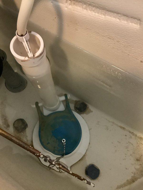 Responded to service call for running toilet with suspected flapper issue. Upon arrival, performed comprehensive inspection of all internal toilet tank components. Found deteriorated blue rubber flapper valve failing to maintain proper seal, causing continuous water flow into bowl. Flapper showed signs of wear and mineral buildup consistent with age of fixture. Inspected fill valve, overflow tube, flush valve assembly, and chain mechanism for additional issues. Tank interior displayed moderate mineral deposits and staining along bottom surfaces and seams. All mounting hardware and connections found secure. Replaced defective flapper valve with new unit. Adjusted chain length to ensure proper flapper seating and complete seal. Tested flush mechanism multiple times to verify proper operation and confirm no continued running. Water flow ceased completely between flush cycles. All internal components now functioning within normal parameters. Toilet operating efficiently with no leaks detec