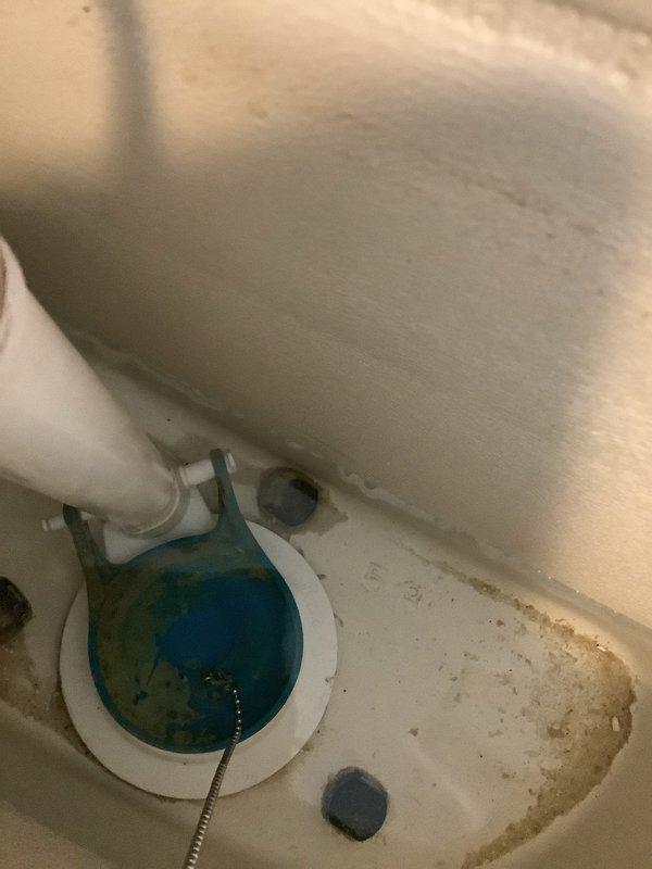 Responded to service call for running toilet with suspected flapper issue. Upon arrival, performed comprehensive inspection of all internal toilet tank components. Found deteriorated blue rubber flapper valve failing to maintain proper seal, causing continuous water flow into bowl. Flapper showed signs of wear and mineral buildup consistent with age of fixture. Inspected fill valve, overflow tube, flush valve assembly, and chain mechanism for additional issues. Tank interior displayed moderate mineral deposits and staining along bottom surfaces and seams. All mounting hardware and connections found secure. Replaced defective flapper valve with new unit. Adjusted chain length to ensure proper flapper seating and complete seal. Tested flush mechanism multiple times to verify proper operation and confirm no continued running. Water flow ceased completely between flush cycles. All internal components now functioning within normal parameters. Toilet operating efficiently with no leaks detec