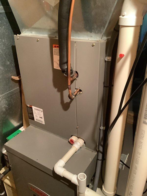 Completed installation of Lennox air conditioning system including outdoor condensing unit and indoor evaporator coil with air handler. Installed outdoor condenser on concrete pad with proper clearances from structure, established refrigerant line connections using copper tubing, and completed electrical wiring with disconnect box mounted to exterior wall. Interior installation included mounting air handler unit in utility room, connecting supply and return ductwork, installing condensate drain lines with PVC piping, and making all necessary refrigerant line connections between indoor and outdoor components. Verified all electrical connections, tested system operation, and confirmed proper drainage.