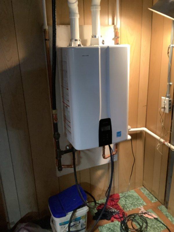 Performed complimentary first-year descaling service on Navien NPE-240A2 natural gas tankless water heater per manufacturer warranty requirements. Completed flush and fill procedure using descaling solution to remove mineral buildup from heat exchanger, ensuring optimal efficiency and performance of the instantaneous water heating system.