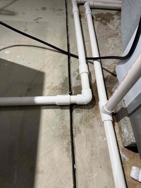 Responded to no cooling complaint on 5-month-old AC system with fan operation confirmed. Upon inspection, discovered condensate drain line issue affecting system performance. Cleared condensate blockage in PVC drain lines, verified proper drainage flow, and tested system operation. Unit returned to normal cooling function with proper airflow and temperature differential restored.