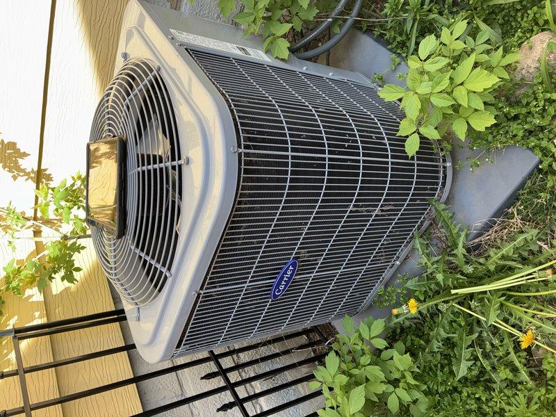Completed spring maintenance and tune-up on Carrier outdoor condensing unit. Inspected control board, electrical connections, and wiring harness; all components found in good operational condition. Noted vegetation overgrowth around unit base and recommended clearance maintenance for optimal airflow and efficiency.
