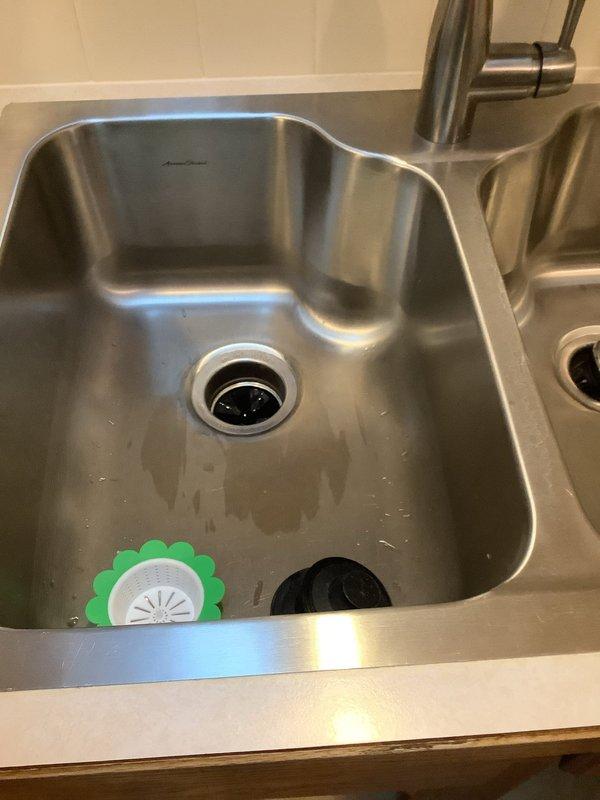Provided quote for sump pump replacement at residential property. Upon inspection, assessed existing sump pump system and determined replacement requirements. Documented current plumbing configuration including under-sink assembly with garbage disposal unit, P-trap connections, and drain line routing for service records.