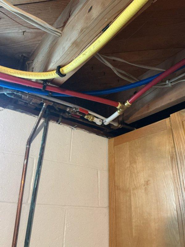 Performed routine maintenance flush on a 3-4 year old electric tanked water heater. Drained sediment buildup from tank bottom through drain valve, flushed system with cold water supply until discharge ran clear, and inspected all plumbing connections including copper supply lines and shut-off valves for proper operation. Verified temperature and pressure relief valve functionality, checked anode rod condition, and confirmed water heater was heating properly after refilling. All components operating within normal parameters with no leaks detected at connections or fittings.