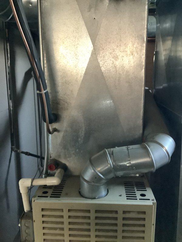 Conducted comprehensive on-site evaluation for complete HVAC system replacement following reported lightning strike and power surge damage. Assessed existing indoor furnace unit with associated ductwork, plenum assembly, and refrigerant line connections in mechanical space. Evaluated outdoor cylindrical condenser unit positioned at foundation level with existing electrical service and conduit routing. Documented current system configuration including copper refrigerant lines, electrical disconnect components, and meter connections. Prepared detailed replacement estimate to match specifications from competing proposal for insurance claim processing related to storm damage.