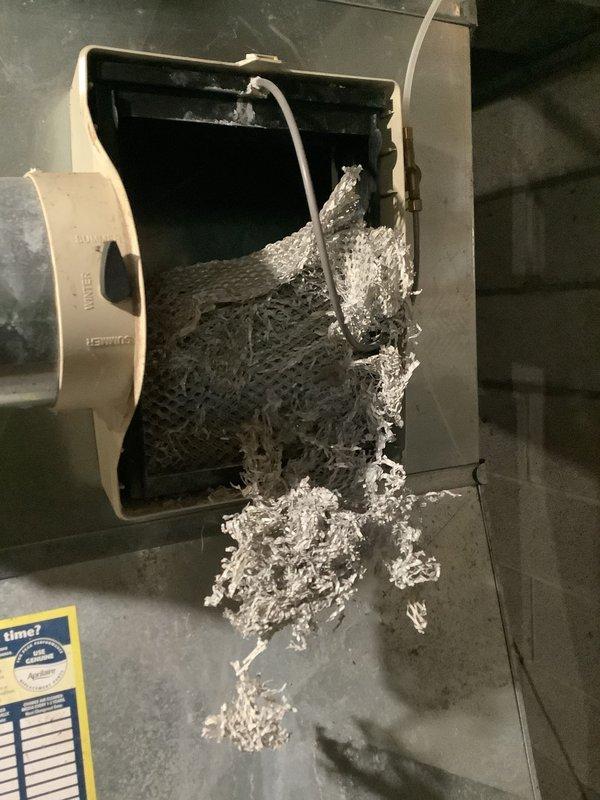 Completed recurring maintenance visit on HVAC system. Upon inspection, discovered severe lint and debris accumulation within air handler cabinet, which was removed to restore proper airflow and prevent potential system efficiency issues or fire hazards. Inspected ductwork, water heater, and associated mechanical components in utility room to ensure all equipment operating within normal parameters.