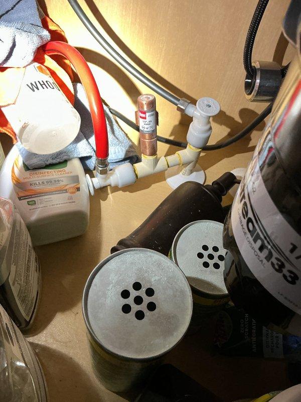 Completed installation of new spigot in garage area and successfully replaced ten shut-off valves throughout the property. Work included accessing plumbing lines in unfinished basement area with exposed joists and insulation, installing new valve assemblies at water heater connections and other critical points in the system, and testing all connections for proper operation and leak-free performance.