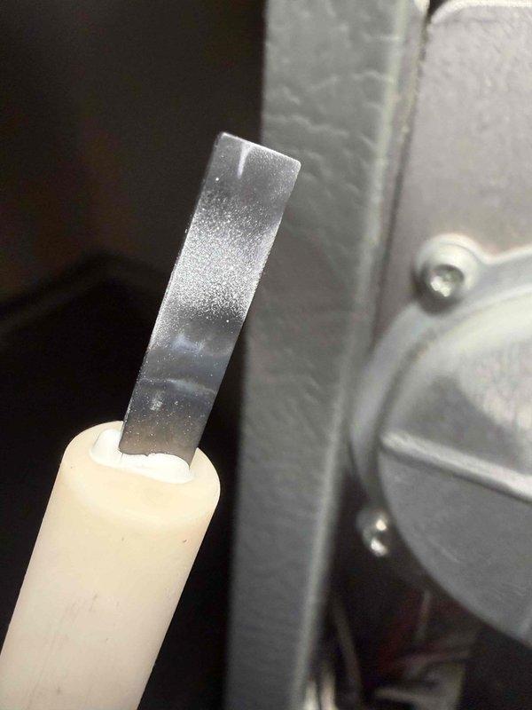 Responded to complaint of gas furnace intermittently blowing cold air after heating cycle. Upon inspection, discovered heavily frosted flame sensor rod, indicating inadequate flame sensing causing burner shutdown. Removed and cleaned flame sensor to restore proper conductivity and system operation. Verified proper heating cycle completion and resolved intermittent cold air issue.