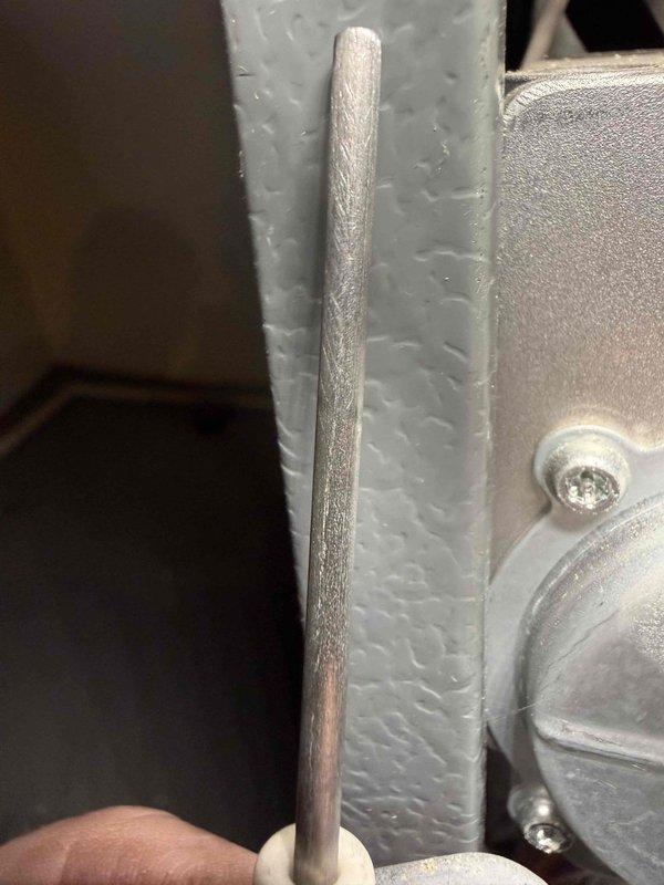 Responded to complaint of gas furnace intermittently blowing cold air after heating cycle. Upon inspection, discovered heavily frosted flame sensor rod, indicating inadequate flame sensing causing burner shutdown. Removed and cleaned flame sensor to restore proper conductivity and system operation. Verified proper heating cycle completion and resolved intermittent cold air issue.