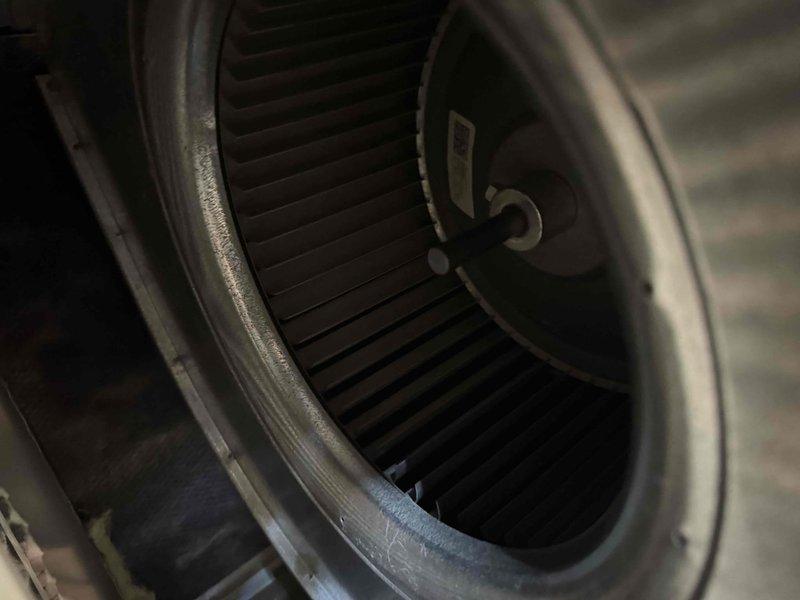 Performed comprehensive annual maintenance on a twelve-year-old air conditioning system. Conducted complete system inspection including blower assembly evaluation, where the squirrel cage fan wheel and motor hub were accessed and inspected for proper operation. The centrifugal blower wheel showed normal dust accumulation on the curved blades consistent with operational use. Verified motor shaft alignment and checked blower wheel for balance and secure mounting. Inspected interior components of the air handler, documenting the condition of the fan assembly and housing. All mechanical components were found to be intact with no signs of damage or unusual wear. System operational parameters confirmed within normal range for a unit of this age.