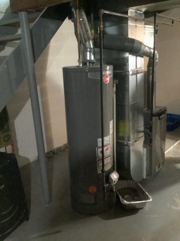 Responded to service call for water heater repair at residential property. Upon arrival, performed comprehensive inspection of tanked water heater unit located in basement mechanical room. Assessed water heater condition, examined all visible connections including copper supply lines and galvanized steel piping, and evaluated overall system performance. Inspected top-mounted pipe connections, pressure relief valve, and related plumbing infrastructure. Verified proper clearances around unit and checked for any signs of leakage or corrosion on tank surface and pipe connections. Documented existing installation with photographs showing water heater positioned adjacent to HVAC furnace system with connected ductwork. Completed necessary repairs to restore water heater to proper working condition and applied promotional discount as requested.