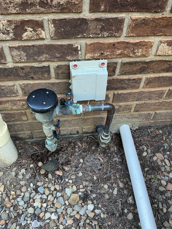 Completed MVP backflow prevention test on system up to 2" in size per regulatory requirements. Tested backflow assembly mounted on exterior brick wall, verified proper operation of check valves and relief valve, and documented water meter readings. All components passed inspection and system is functioning within acceptable parameters for cross-connection control.