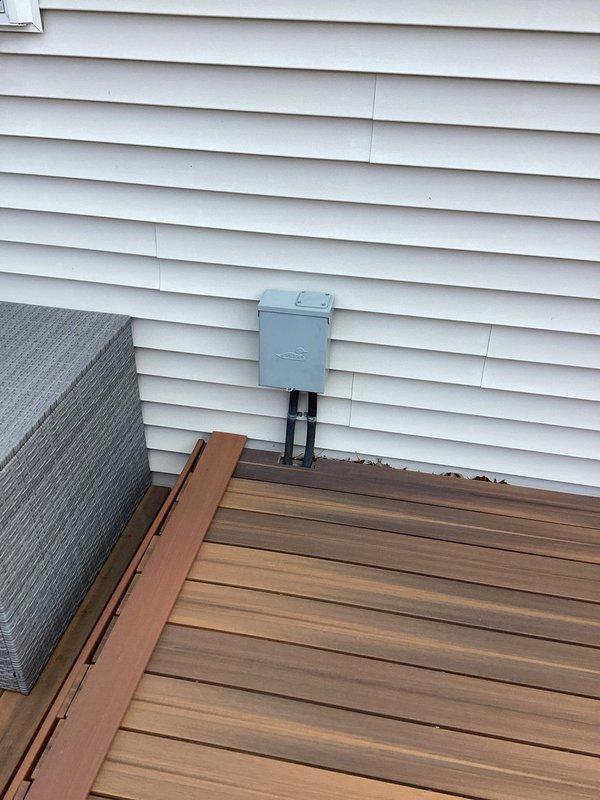 Responded to service call for electrical outlet near hot tub requiring decommissioning. Successfully capped off the outdoor electrical receptacle mounted on exterior siding adjacent to deck area to eliminate potential safety hazard near water feature. Verified proper termination of wiring and secured weatherproof cover plate to protect against moisture intrusion.