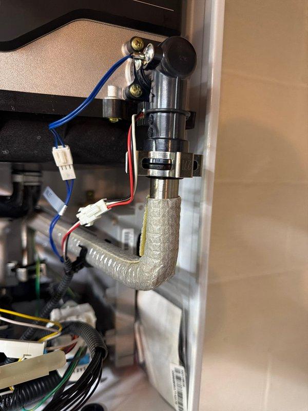 Completed installation of new internal check valve and flow sensor on existing Navien 240a tankless water heater. Accessed internal components of the unit, integrated the flow sensor into the water supply line, and installed the check valve to prevent backflow and ensure proper system operation. All connections were secured with appropriate fittings, electrical connections were made to the control board, and the unit was tested to verify proper flow detection and valve function. The water heater was reassembled and returned to full operational status.