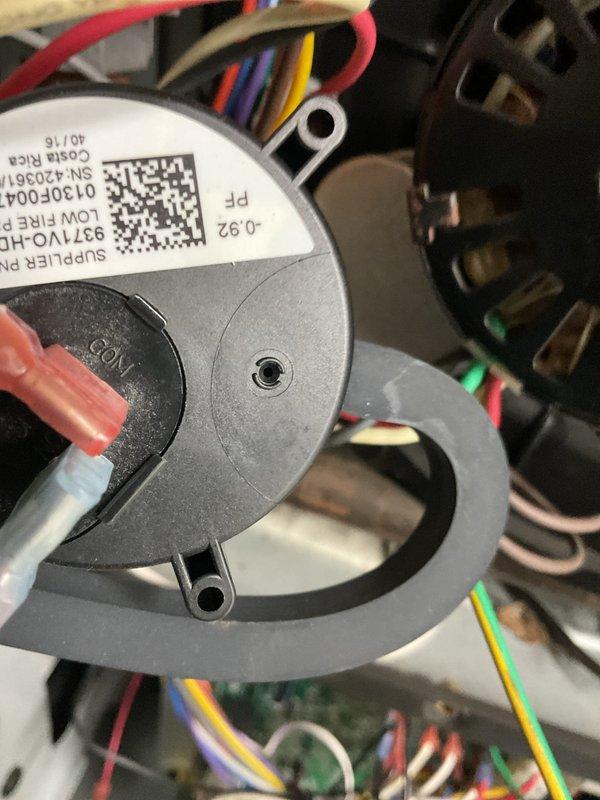 Responded to no heat call on gas furnace with no operation or sound. Upon inspection, found inducer motor and pressure switch assembly not functioning. Diagnosed failed pressure switch preventing ignition sequence from initiating. Verified all electrical connections at motor and switch were secure, tested continuity across pressure switch contacts and confirmed open circuit. Replaced defective pressure switch, restored power to unit, and verified proper inducer motor operation and successful call for heat with burner ignition.