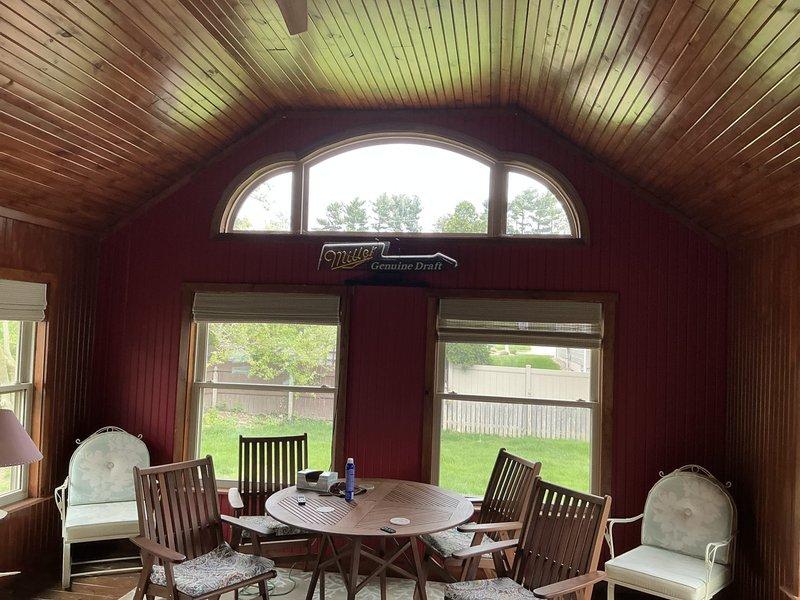 Conducted on-site assessment for mini split installation in enclosed patio/sunroom with vaulted beadboard ceiling and wood-paneled walls. Evaluated space layout, electrical requirements, and optimal placement for indoor air handler and outdoor condenser unit to provide efficient climate control for the three-season room.