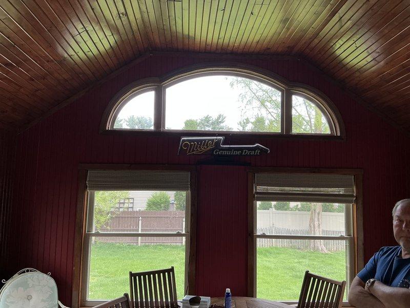 Conducted on-site assessment for mini split installation in enclosed patio/sunroom with vaulted beadboard ceiling and wood-paneled walls. Evaluated space layout, electrical requirements, and optimal placement for indoor air handler and outdoor condenser unit to provide efficient climate control for the three-season room.