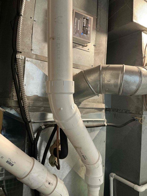 Conducted on-site assessment of existing Lennox HVAC system in mechanical room to provide replacement estimate. Evaluated current furnace/air handler configuration, PVC condensate drainage system, metal ductwork connections, and electrical components to determine equipment specifications and installation requirements for complete system replacement.