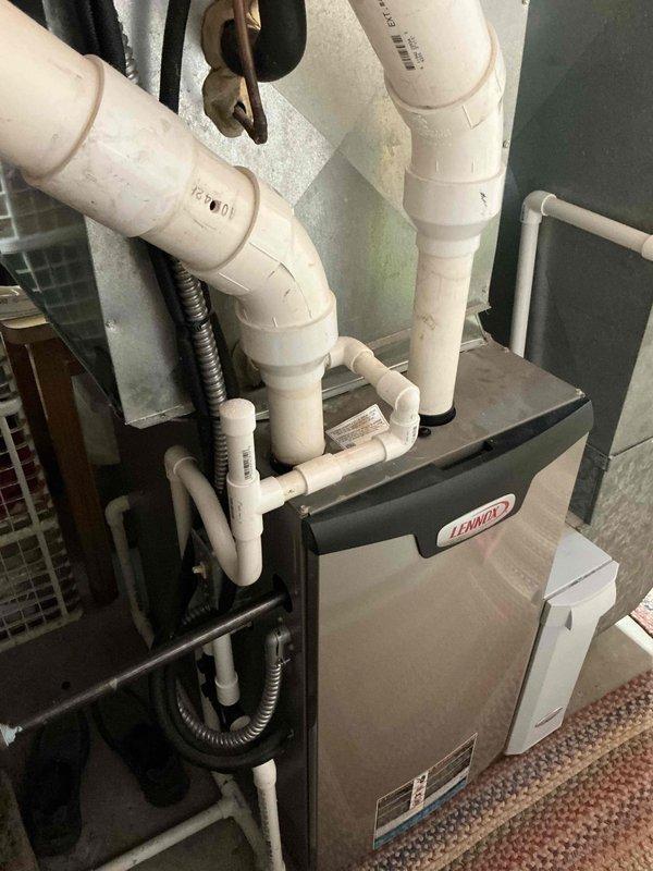 Conducted on-site assessment of existing Lennox HVAC system in mechanical room to provide replacement estimate. Evaluated current furnace/air handler configuration, PVC condensate drainage system, metal ductwork connections, and electrical components to determine equipment specifications and installation requirements for complete system replacement.
