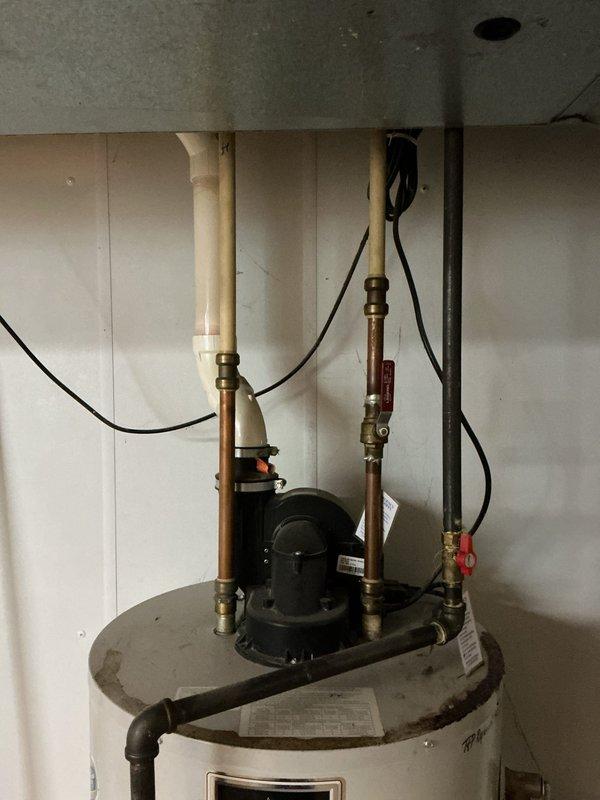 Completed comprehensive evaluation of tanked water heater system including inspection of tank condition, circulation pump, copper supply lines, brass valves, and PVC discharge piping. Assessed all plumbing connections, electrical components, and mounting hardware in crawl space installation. Documented existing equipment configuration with photographic evidence and provided replacement estimate to customer based on findings.