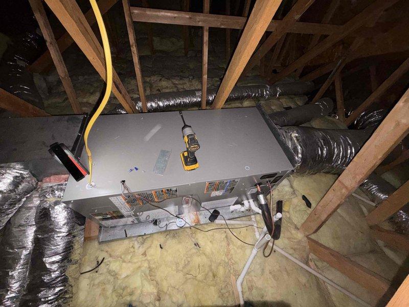 Completed full HVAC system replacement including installation of new Lennox condenser unit on exterior pad with proper clearances and landscaping considerations, and new air handler installed in attic space with appropriate electrical conduit routing, flexible ductwork connections, and proper placement over insulated joists. All equipment secured, wired, and tested for proper operation with refrigerant lines connected between indoor and outdoor units.