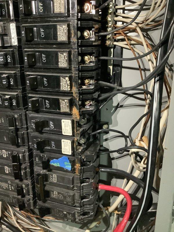 Responded to reported water leak near electrical panel in 35-year-old residential property. Upon arrival, inspected main breaker panel and surrounding area for active moisture intrusion and potential electrical hazards. No active leak was observed at time of inspection. Documented existing panel configuration showing multiple circuit breakers with visible wire bundles and connections. Assessed panel condition, noting some discoloration on breakers and mounting areas that may indicate previous moisture exposure. Photographed electrical panel installation, wiring routes through wall opening, and breaker arrangement for documentation purposes. Provided customer with assessment findings regarding panel condition and recommendations for monitoring the area for future water intrusion that could compromise electrical safety.