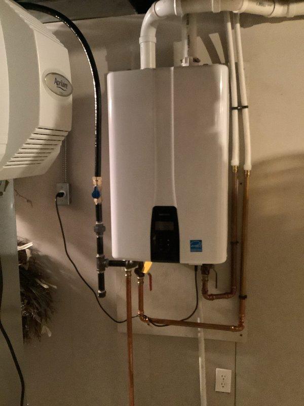 Responded to service call for 3-year-old tankless water heater experiencing intermittent and inconsistent hot water delivery. Upon arrival, performed comprehensive diagnostic evaluation of the unit, including inspection of gas supply lines, water flow sensors, heat exchanger, and electronic control board. Examined copper supply and return piping connections at base of unit for proper flow and pressure. Verified PVC venting system installation and clearances met manufacturer specifications. Assessed unit's operational performance through multiple heating cycles to identify source of inconsistent temperature output. Documented equipment condition and installation configuration with photographic evidence showing Energy Star certified tankless unit with proper mounting, gas and water line connections with shutoff valves, and exhaust venting routed through ceiling. System evaluated for potential issues including mineral buildup, flow rate restrictions, ignition sequencing problems, or flame