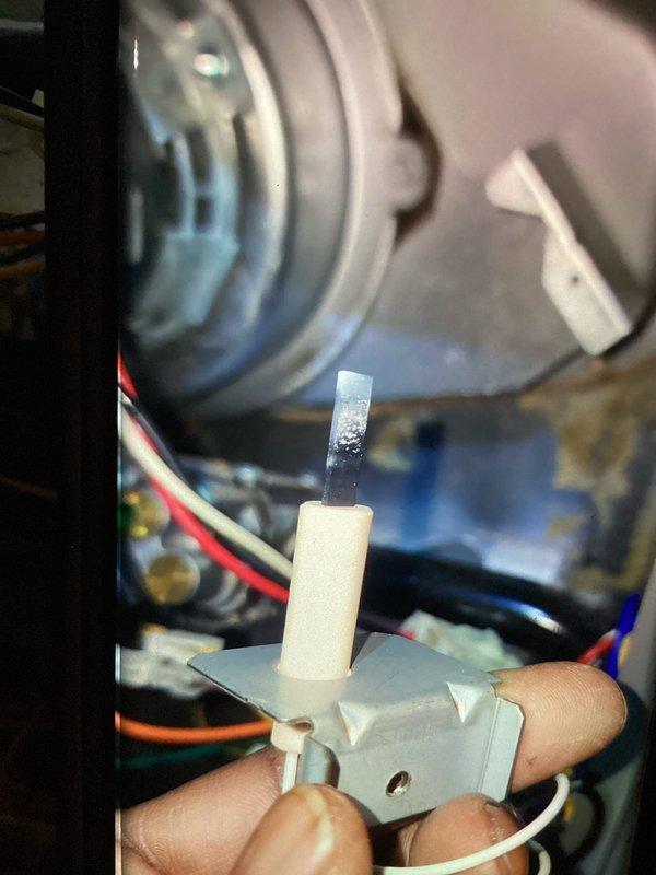 Responded to no heat call on 9-year-old furnace. Upon arrival, system was running but producing no heat with house temperature at 61°. Diagnosed failed flame sensor preventing ignition sequence from completing. Removed and inspected sensor, confirming heavy carbon buildup and oxidation preventing proper flame detection. Cleaned sensor thoroughly and reinstalled. Cycled system multiple times to verify proper ignition, flame proving, and heat production. System now heating normally with all safety controls functioning as designed.