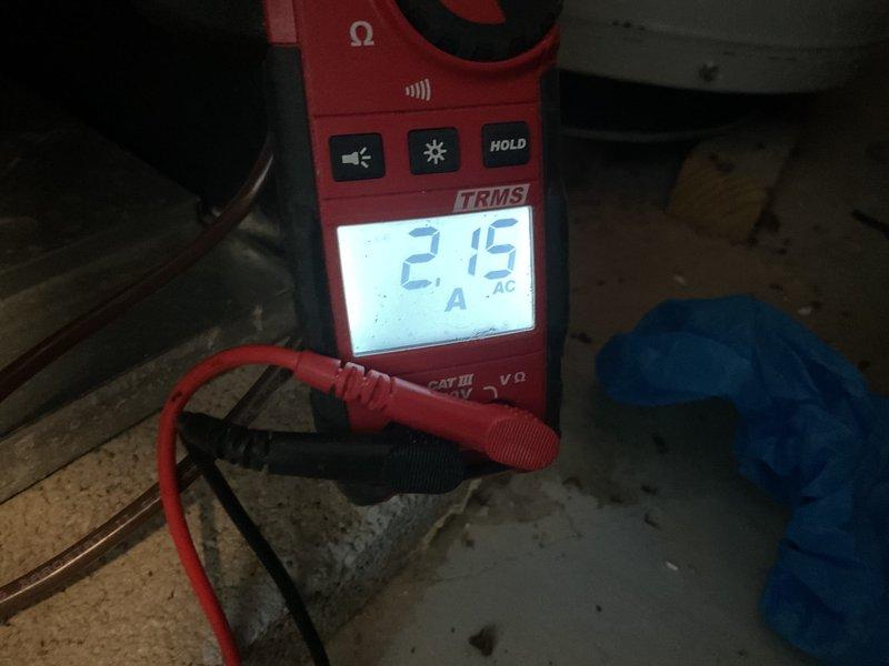 Completed comprehensive tune-up on gas furnace and air conditioning system of unknown age. Performed electrical diagnostics using clamp meter, measuring amperage draw on AC refrigeration lines to verify compressor performance within manufacturer specifications at 2.15 amps. Inspected Aprilaire humidifier unit, noting previous service date of 5/20/24, and verified proper operation and mounting. Evaluated ductwork condition for potential cleaning needs and provided CO detector per promotional offer.