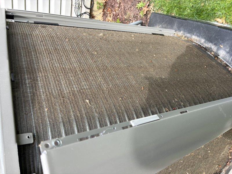 Performed routine maintenance on a 2-year-old air conditioning system under manufacturer's MVP program. Inspected and cleaned outdoor condenser coil which showed moderate dirt and debris accumulation on aluminum fins. Cleared condensate drain line of mineral deposits and verified proper drainage flow to prevent future blockages.