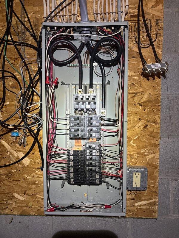 Completed installation of 22kW standby generator system with cold weather kit and whole home surge protection. Installed 200-amp automatic transfer switch with new electrical panel, ran 60 feet of electrical line from main service to transfer switch location, and coordinated with gas utility contractor for 10-foot gas line connection. Configured transfer switch to eliminate disconnect requirement per engineering specifications, performed complete system commissioning and testing to verify proper automatic transfer operation and generator functionality under load conditions.