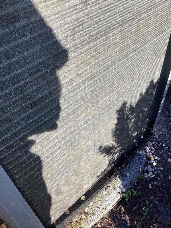 Completed maintenance inspection on 1-year-old heat pump system per MVP agreement. Customer reported excessive noise during operation. Upon arrival, performed standard cooling season maintenance protocol including visual inspection of outdoor unit. Examined condenser coil and found moderate accumulation of dirt, dust, and debris on fins, with visible discoloration indicating environmental exposure. Noted debris buildup at base of unit near foundation level. Assessed unit operation and confirmed noise concern. Documented equipment condition with photos showing exterior unit placement, condenser coil condition, and debris accumulation. System operational at time of inspection.