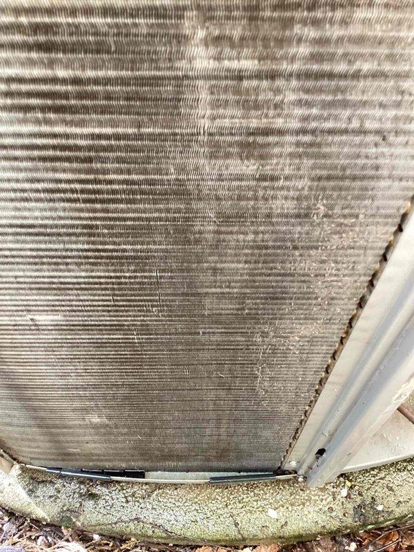 Completed maintenance inspection on 1-year-old heat pump system per MVP agreement. Customer reported excessive noise during operation. Upon arrival, performed standard cooling season maintenance protocol including visual inspection of outdoor unit. Examined condenser coil and found moderate accumulation of dirt, dust, and debris on fins, with visible discoloration indicating environmental exposure. Noted debris buildup at base of unit near foundation level. Assessed unit operation and confirmed noise concern. Documented equipment condition with photos showing exterior unit placement, condenser coil condition, and debris accumulation. System operational at time of inspection.