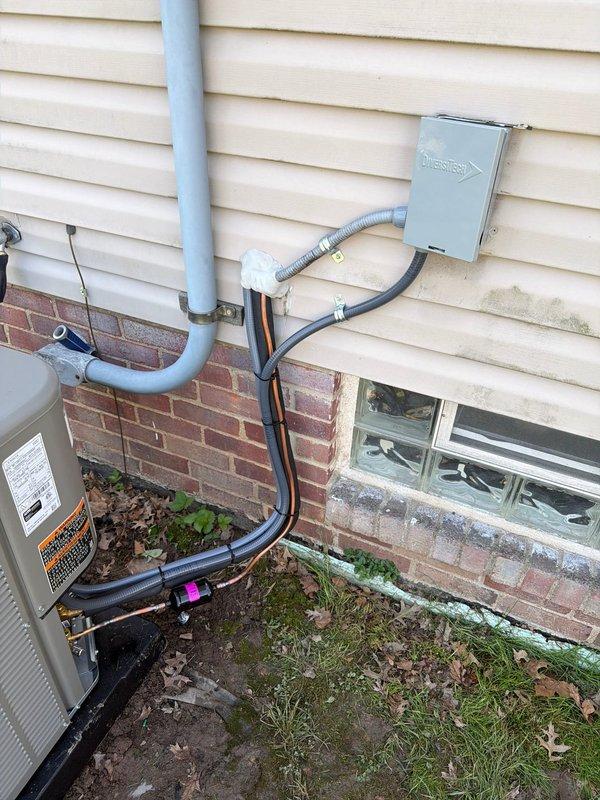 Completed installation of new residential air conditioning system with matching evaporator coil. Outdoor condensing unit was mounted on exterior wall with proper refrigerant line sets, electrical disconnect, and conduit connections routed through vinyl siding, while indoor evaporator coil was installed on existing WeatherMaker 8000 furnace with appropriate ductwork modifications and condensate drainage. System was tested and confirmed operational with all components properly secured and connected to manufacturer specifications.