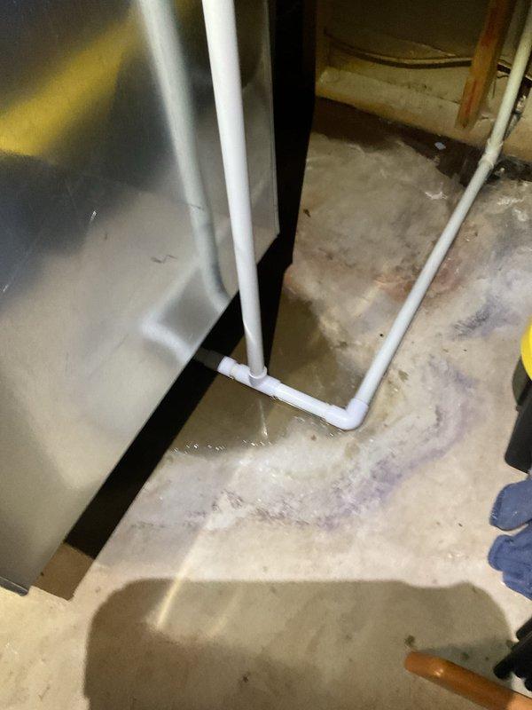 Responded to no heat call on 2-year-old natural gas furnace displaying error code. Unit attempted ignition sequence but failed to fire. Upon arrival, discovered significant water infiltration on basement floor surrounding furnace area. Determined condensate drainage system failure causing water accumulation around equipment base, which triggered safety lockout preventing ignition. Condensate line obstruction cleared and drainage system restored to proper operation. Verified furnace resumed normal heating cycle after water issue resolved and safety controls reset.