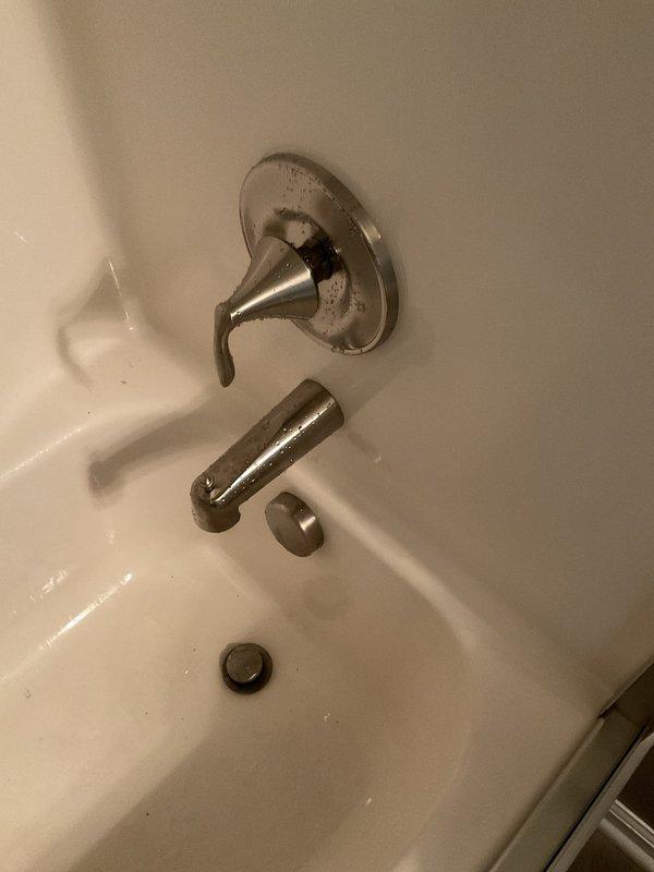Removed existing single-handle shower valve and tub spout from bathroom installation. Accessed plumbing infrastructure through wall opening to disconnect old fixtures from copper supply lines. Installed new Moen Eva brushed nickel shower valve with matching escutcheon plate and new tub spout with diverter. Completed all soldering connections, tested water flow and temperature control, and verified proper operation of diverter mechanism.