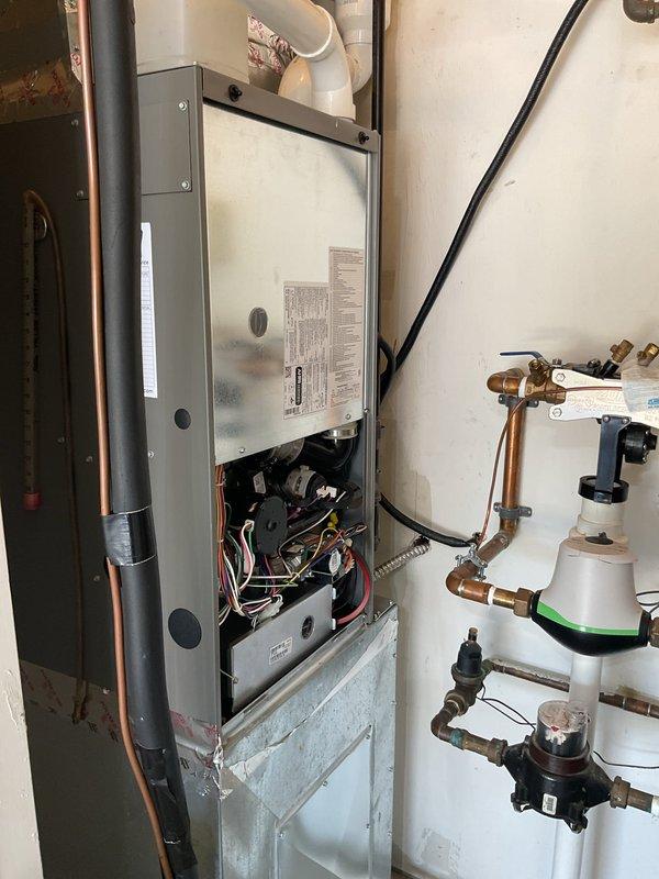 Responded to service call and arrived on-site as scheduled for recurring maintenance visit on a 6-year-old cooling system. Upon arrival, performed comprehensive inspection of the HVAC equipment, including examination of the wall-mounted unit's internal components, electrical connections, and associated plumbing infrastructure. Documented system condition through photographic records showing the equipment cabinet, wiring configuration with multiple colored conductors, circuit boards, copper piping with brass fittings and valves, and insulated refrigerant lines. All components were found to be properly mounted and secured, with plumbing connections and control valves functioning within normal parameters. System inspection completed successfully with equipment operating as designed.