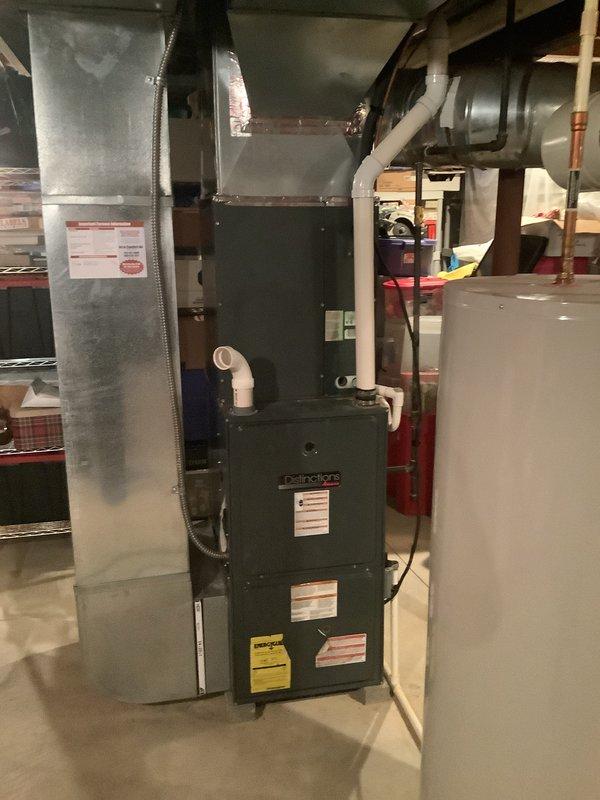 Completed full HVAC system installation including 90% AFUE gas furnace and air conditioning condenser unit. Installed furnace in basement mechanical room with proper venting using white PVC piping, connected to existing ductwork infrastructure via galvanized metal plenum and flexible duct connectors. Routed copper refrigerant lines from basement to exterior condenser location, installed attic ductwork components with insulated plenum box to ensure proper airflow distribution throughout residence. Verified all electrical connections, tested system operation for heating and cooling cycles, confirmed proper condensate drainage, and ensured all safety controls functioning within manufacturer specifications.