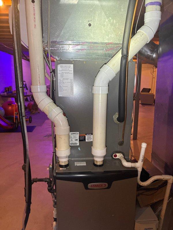Performed routine air conditioning maintenance visit on 9-year-old Lennox HVAC system for MVP customer. Inspected outdoor condensing unit electrical compartment, verifying proper operation of capacitor, contactors, and relay connections. Documented extensive wiring configuration including power and control circuits. Examined indoor air handler and furnace assembly, checking PVC condensate drainage lines and venting connections for proper installation and functionality. All electrical components, refrigerant connections, and drainage systems found operating within normal parameters.