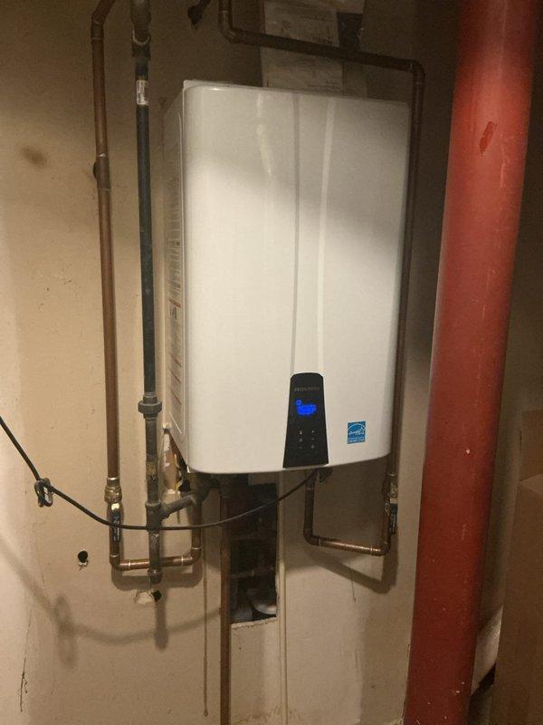 Performed routine maintenance and descaling service on wall-mounted tankless water heater unit. Flushed system with descaling solution to remove mineral buildup and sediment accumulation from heat exchanger, ensuring optimal performance and efficiency. Verified proper operation of unit upon completion, with all connections secure and system functioning within manufacturer specifications.