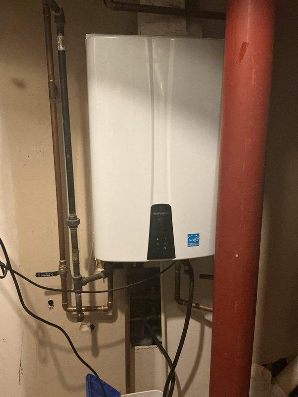 Performed routine maintenance and descaling service on wall-mounted tankless water heater unit. Flushed system with descaling solution to remove mineral buildup and sediment accumulation from heat exchanger, ensuring optimal performance and efficiency. Verified proper operation of unit upon completion, with all connections secure and system functioning within manufacturer specifications.