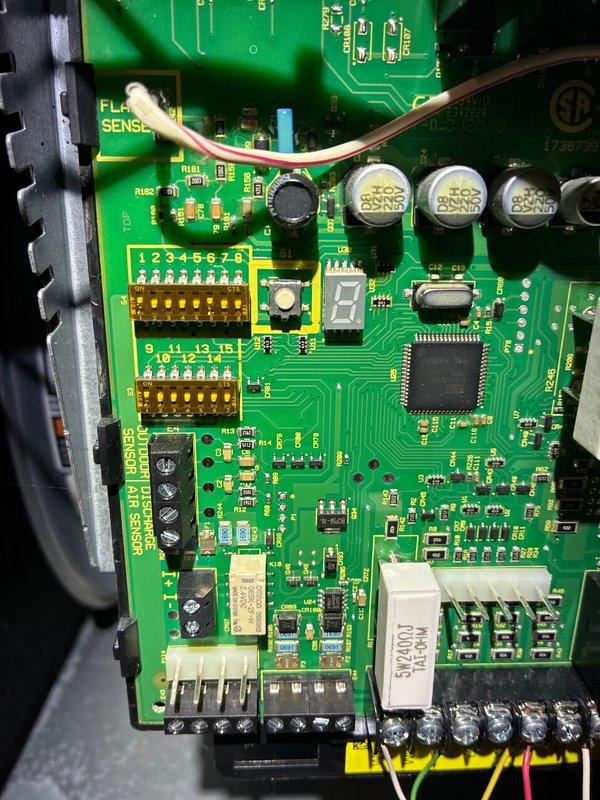 Completed scheduled air conditioning maintenance visit for MVP customer with 8-year-old system. Performed comprehensive cooling system inspection and preventative maintenance procedures. Installed surge protector on furnace control board to provide electrical protection for electronic components. Inspected furnace control board showing integrated circuits, flame sense connections, and multi-pin wire harnesses in proper working condition. Noted significant condensation present on supply ductwork extending from furnace unit, indicating active cooling operation and potential humidity levels in basement environment. All equipment operational upon completion of service visit.