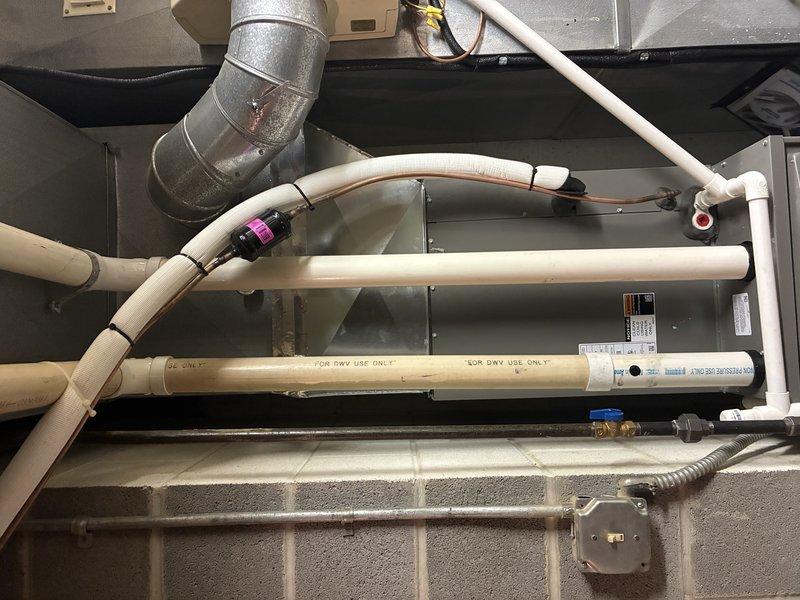 Completed routine MVP heating maintenance visit on residential HVAC system. Performed comprehensive inspection of furnace mechanical components, condensate drainage system with PVC piping, and ductwork connections. Verified proper operation of Aprilaire whole-house humidifier unit including control settings, water supply connections, and electrical components to ensure optimal system performance for the heating season.